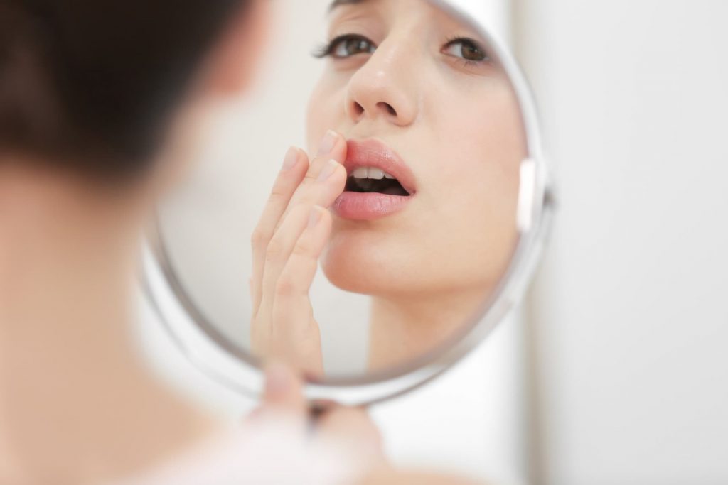 Woman looking at herself in the mirror